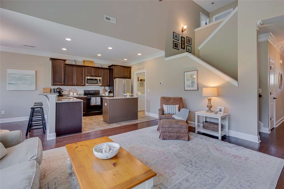 203 Streams Way Anderson, SC 29625 - Photo 16 of 47 This inviting space combines a cozy living area with a functional kitchen, perfect for everyday living.