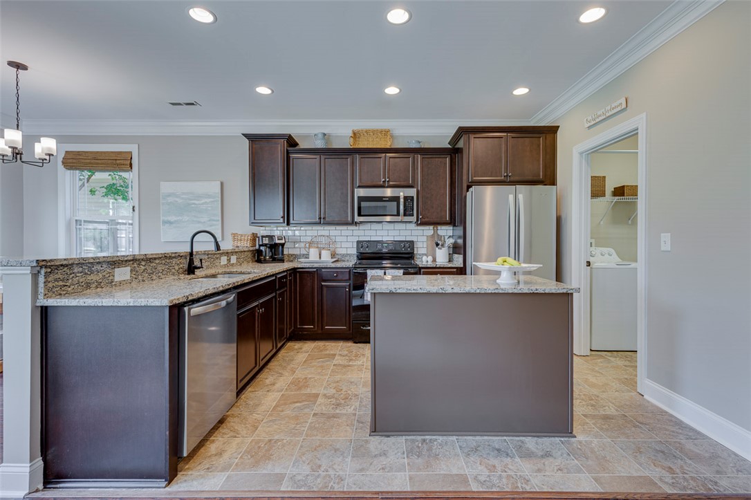 203 Streams Way Anderson, SC 29625 - Photo 18 of 47 This spacious kitchen offers ample granite countertops and modern appliances, perfect for everyday living.