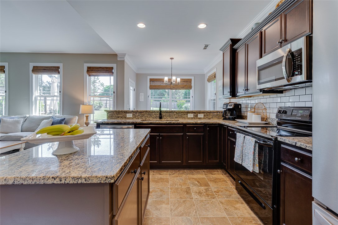 203 Streams Way Anderson, SC 29625 - Photo 22 of 47 This spacious kitchen offers ample counter space and connects seamlessly to a bright living area.