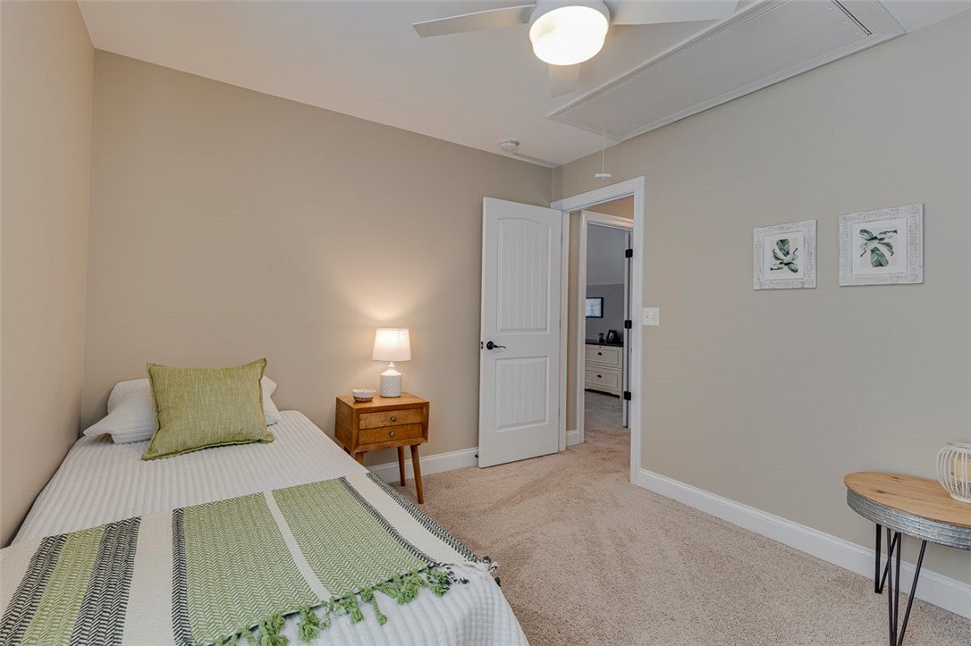 203 Streams Way Anderson, SC 29625 - Photo 30 of 47 This cozy bedroom features carpeted floors and a ceiling fan, offering comfort and style.