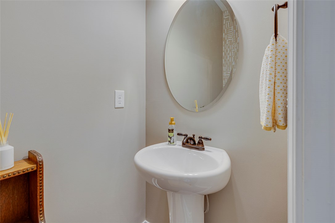 203 Streams Way Anderson, SC 29625 - Photo 6 of 47 This powder room features a classic pedestal sink and an elegant oval mirror.