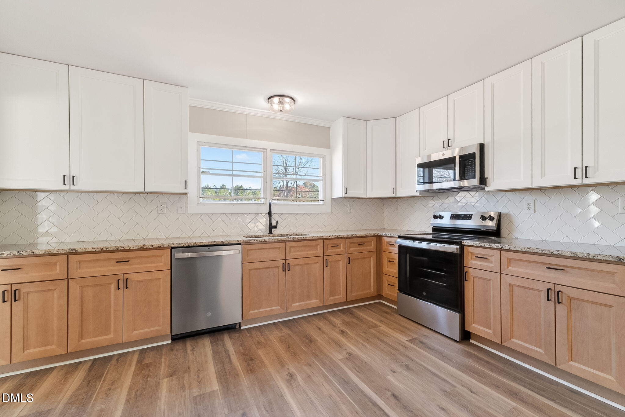 10015 Smith Road Middlesex, NC 27557 - Photo 18 of 48 a kitchen with granite countertop cabinets stainless steel appliances and a sink