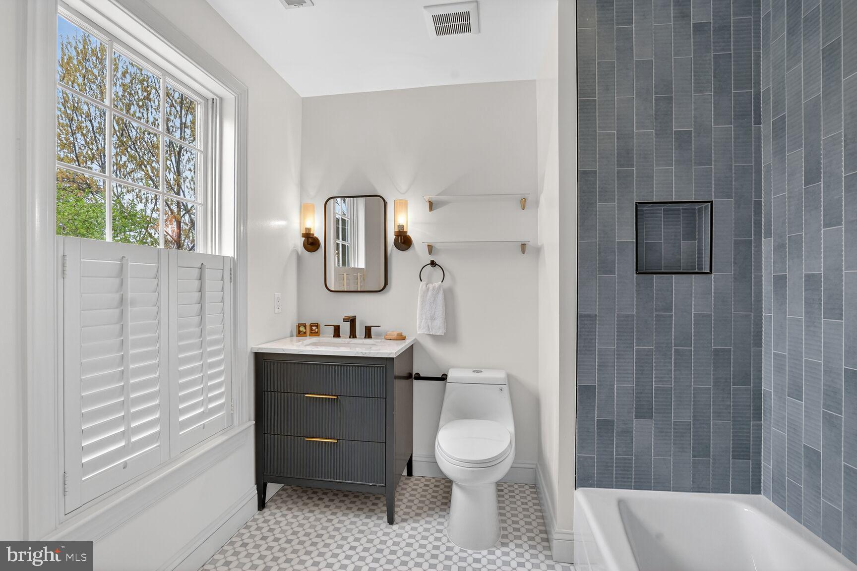 4837 W Street Northwest Washington, DC 20007 - Photo 33 of 51 a bathroom with a sink a toilet and shower