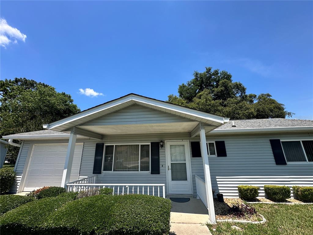 11150 Southwest 76th Avenue Ocala, FL 34476 - Photo 1 of 12 a front view of a house with a yard