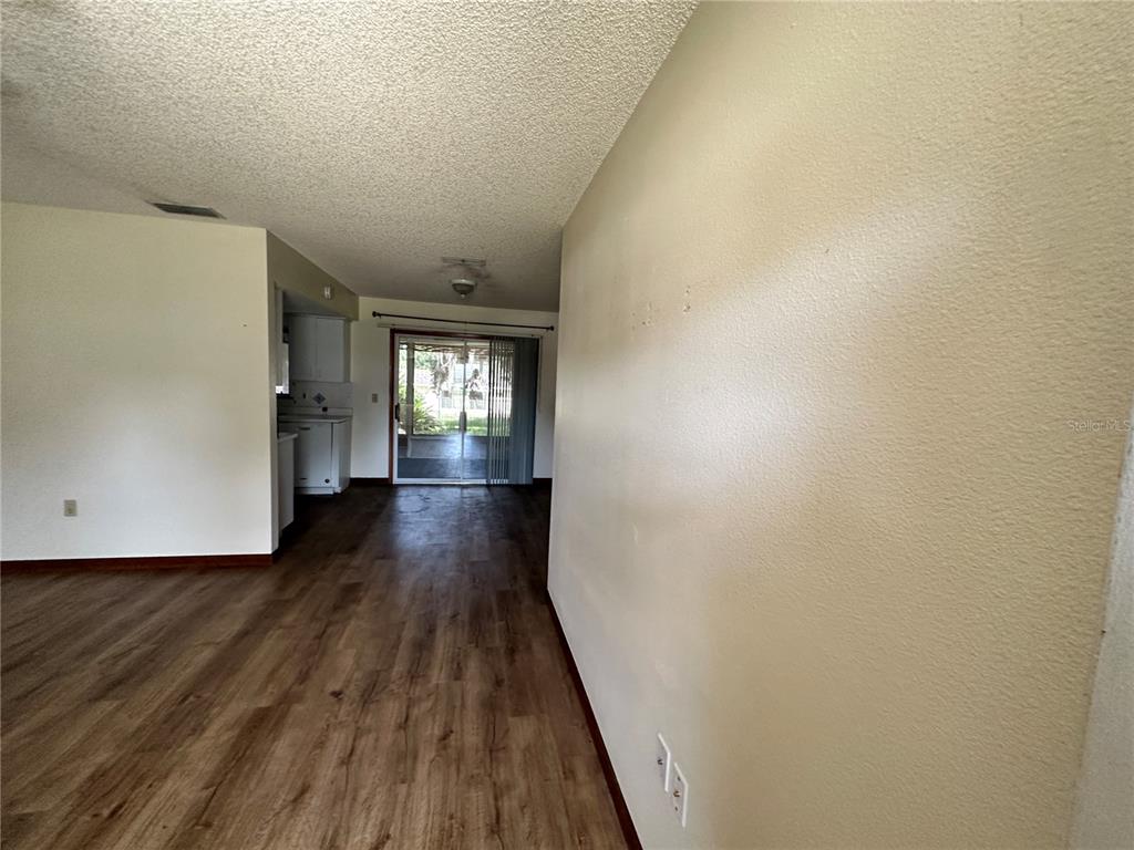 11150 Southwest 76th Avenue Ocala, FL 34476 - Photo 3 of 12 a view of hallway with wooden floor