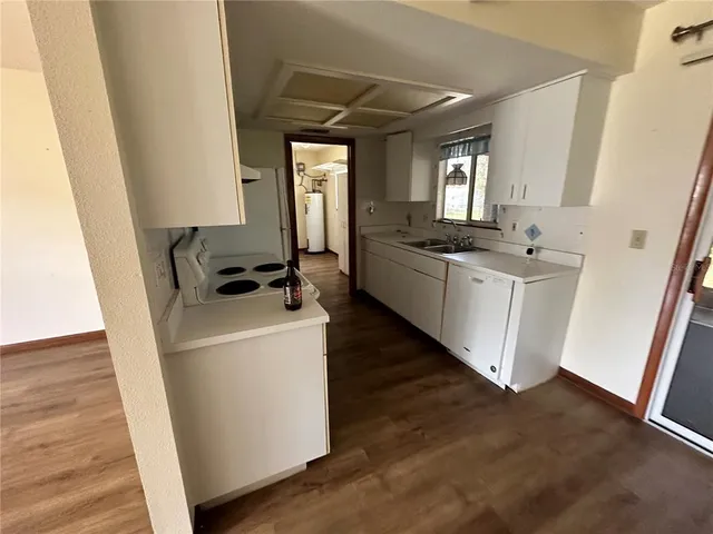a kitchen with sink a stove and refrigerator