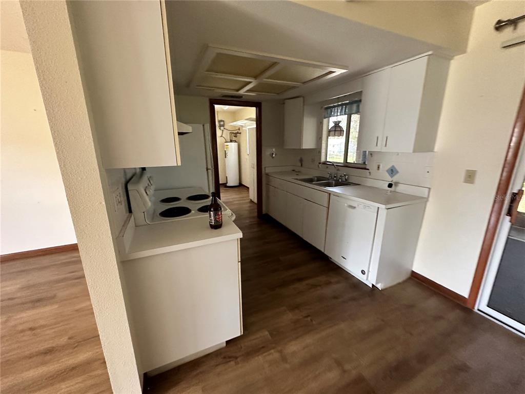 11150 Southwest 76th Avenue Ocala, FL 34476 - Photo 5 of 12 a kitchen with sink a stove and refrigerator