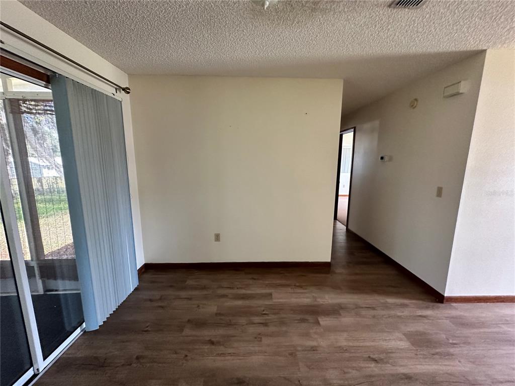 11150 Southwest 76th Avenue Ocala, FL 34476 - Photo 7 of 12 a view of an empty room with wooden floor and a window