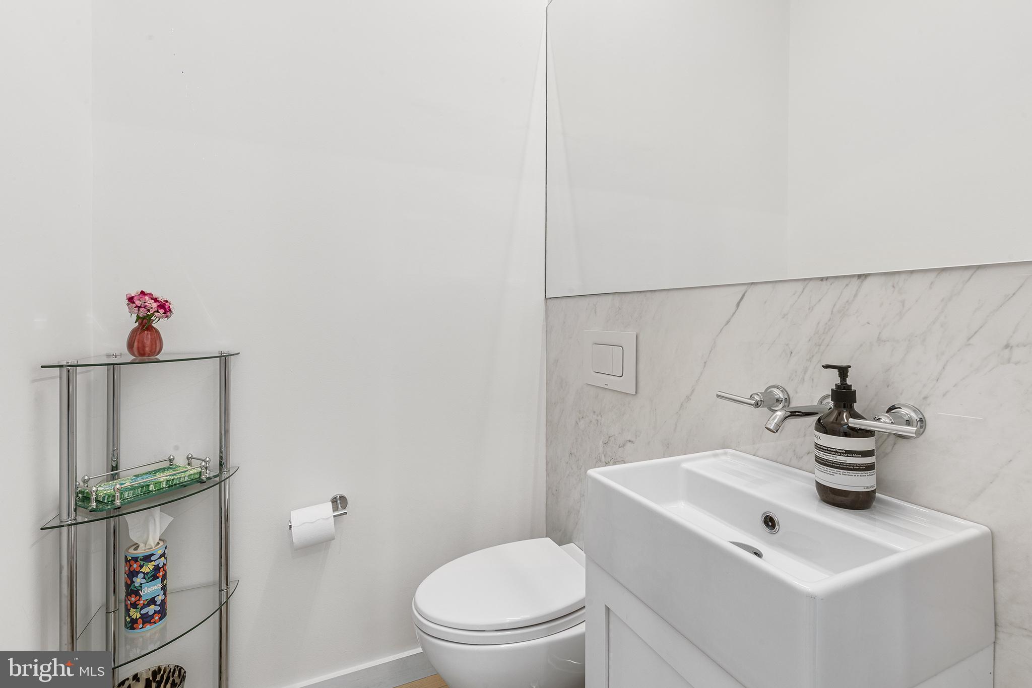 116 North Croskey Street Philadelphia, PA 19103 - Photo 19 of 57 a bathroom with a toilet a sink and a mirror