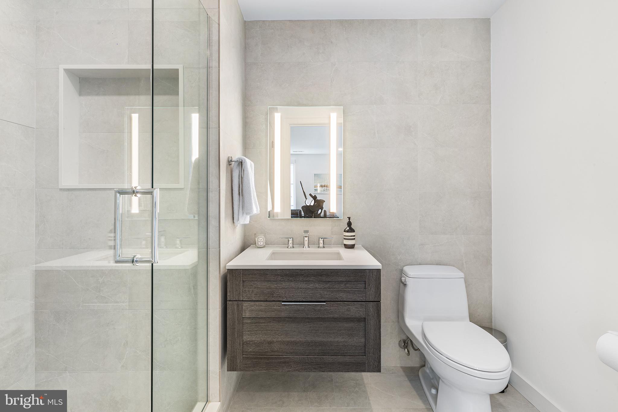 116 North Croskey Street Philadelphia, PA 19103 - Photo 28 of 57 a bathroom with a toilet a sink and a mirror