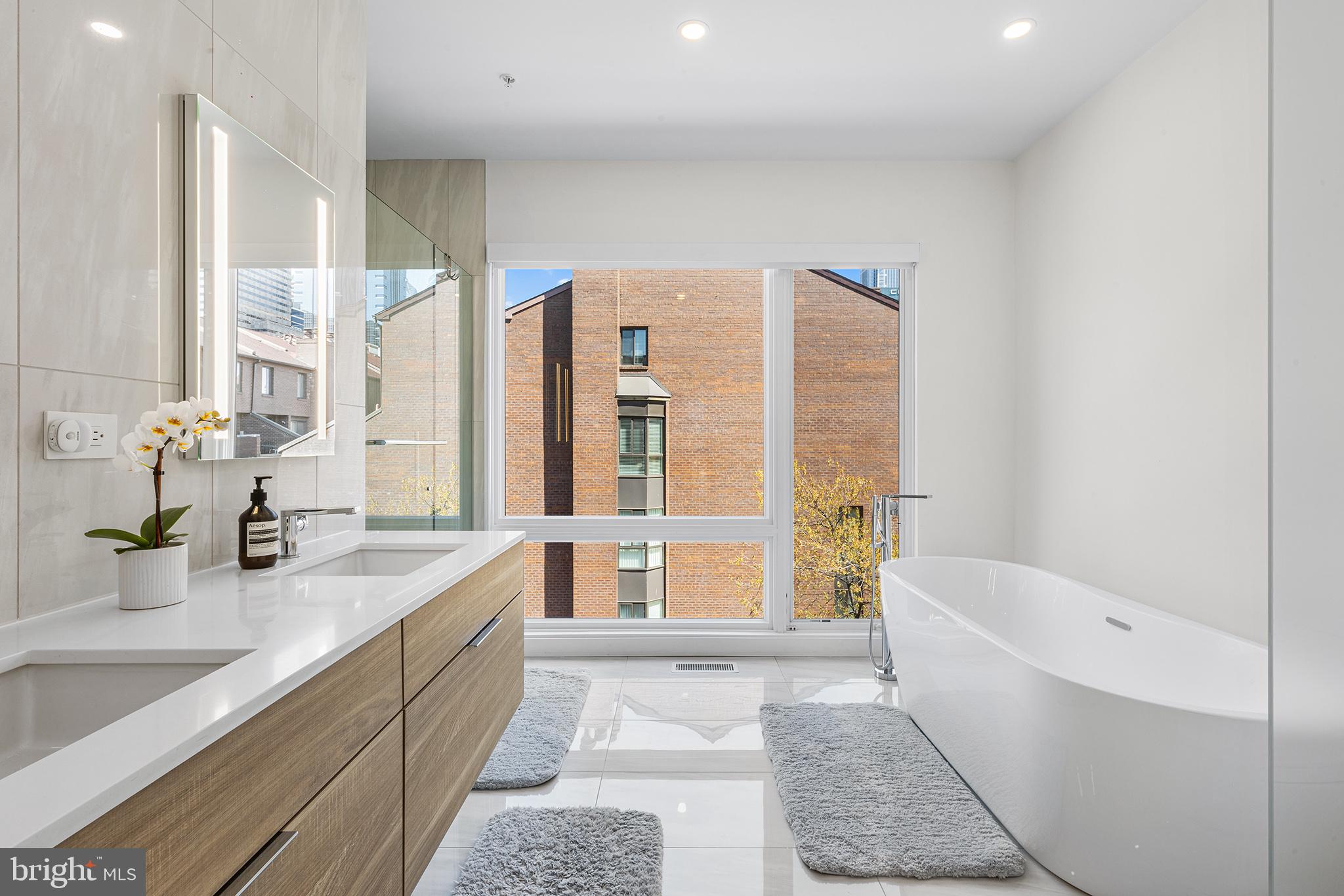 116 North Croskey Street Philadelphia, PA 19103 - Photo 32 of 57 a spacious bathroom with a tub sink and mirror