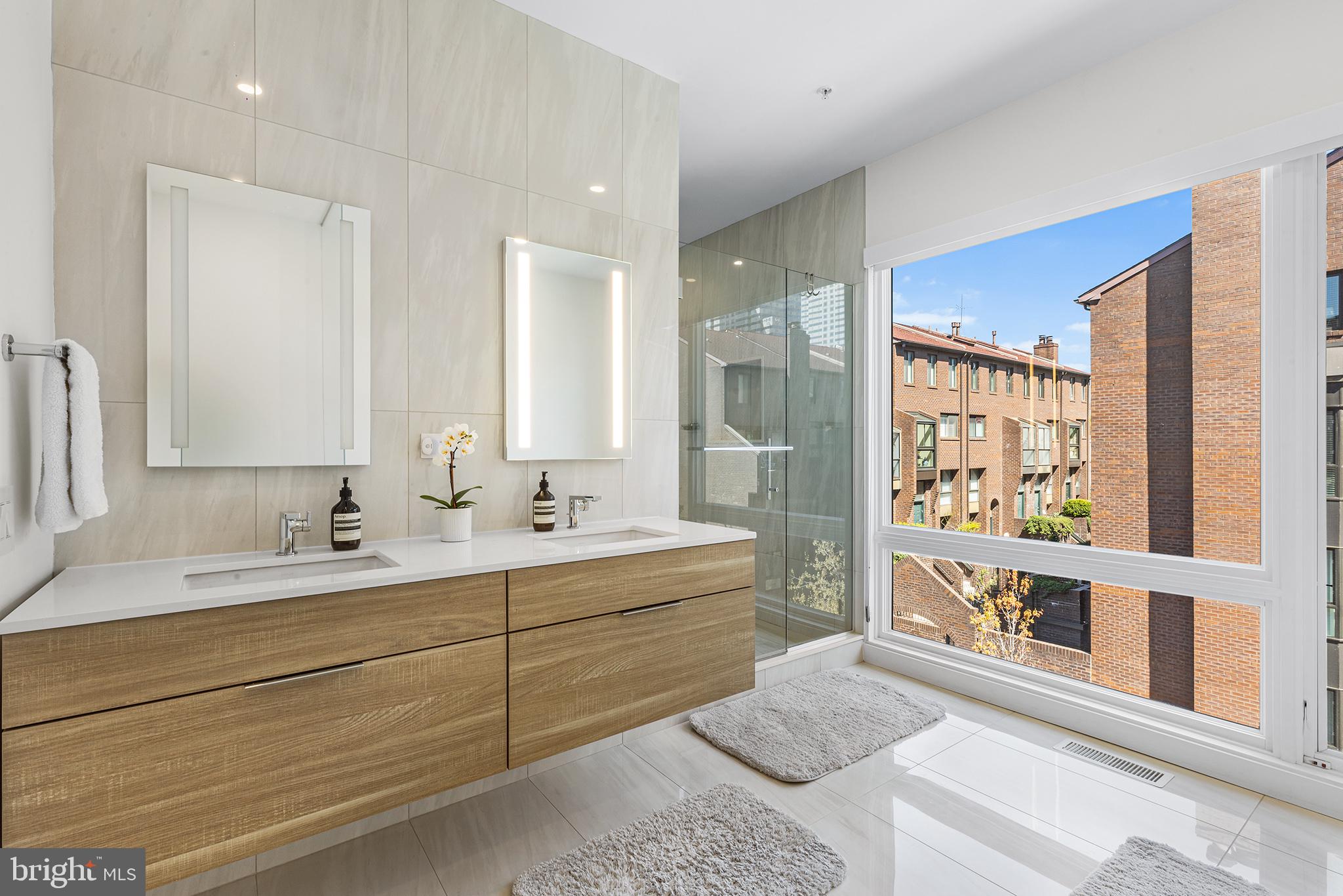 116 North Croskey Street Philadelphia, PA 19103 - Photo 33 of 57 a bathroom with a double vanity sink a mirror and a bathtub