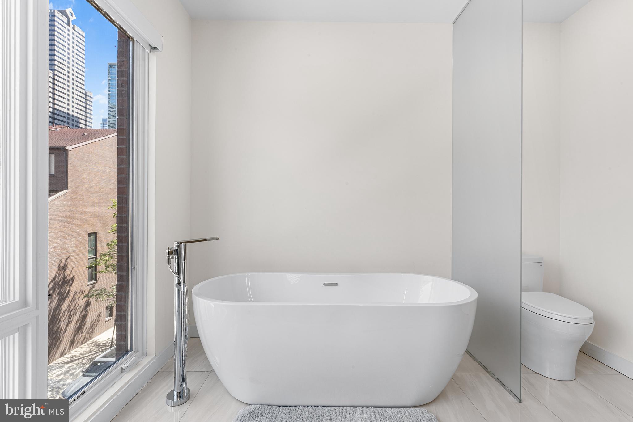 116 North Croskey Street Philadelphia, PA 19103 - Photo 34 of 57 a white bath tub sitting next to a white toilet