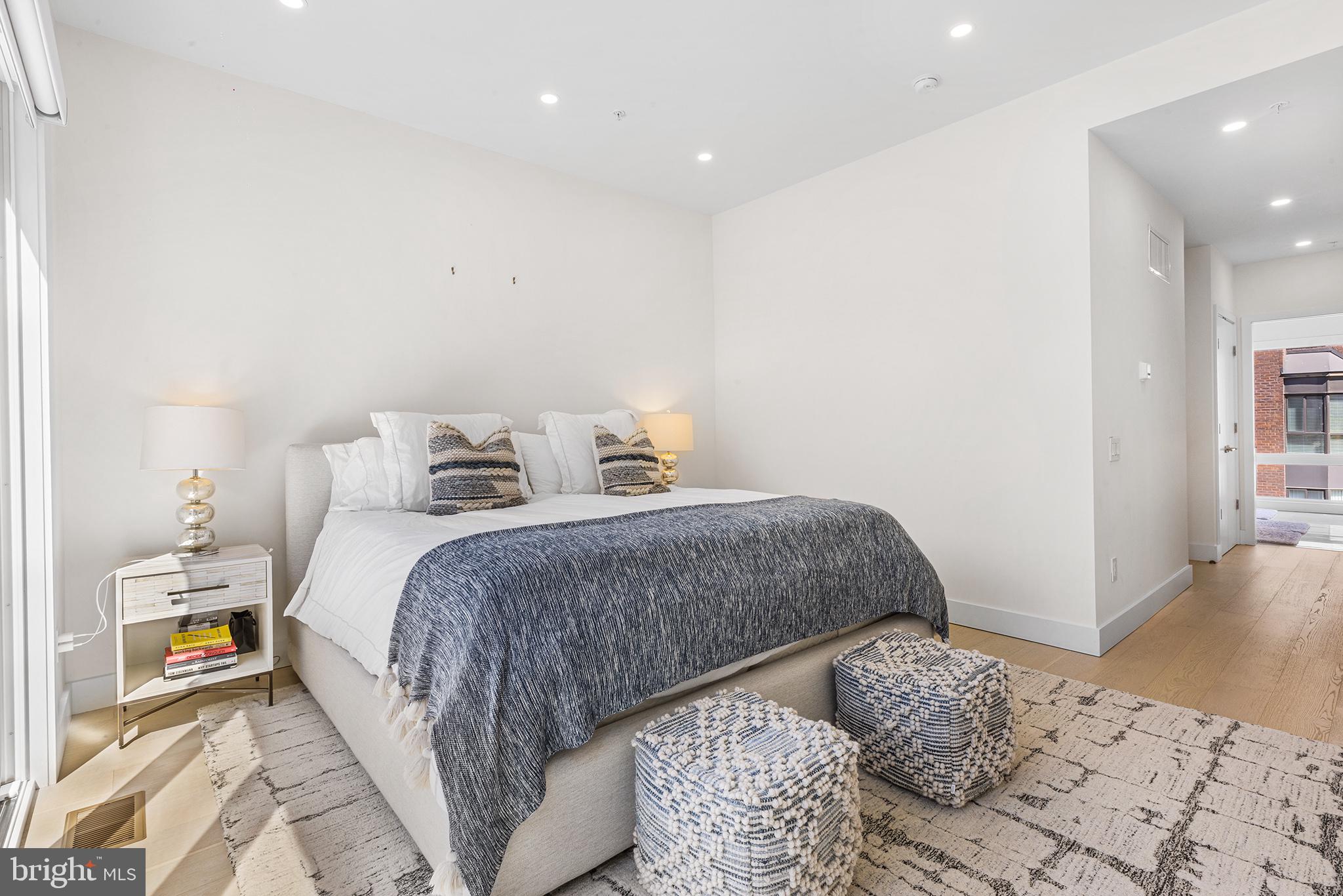 116 North Croskey Street Philadelphia, PA 19103 - Photo 37 of 57 a bedroom with a bed and wooden floor