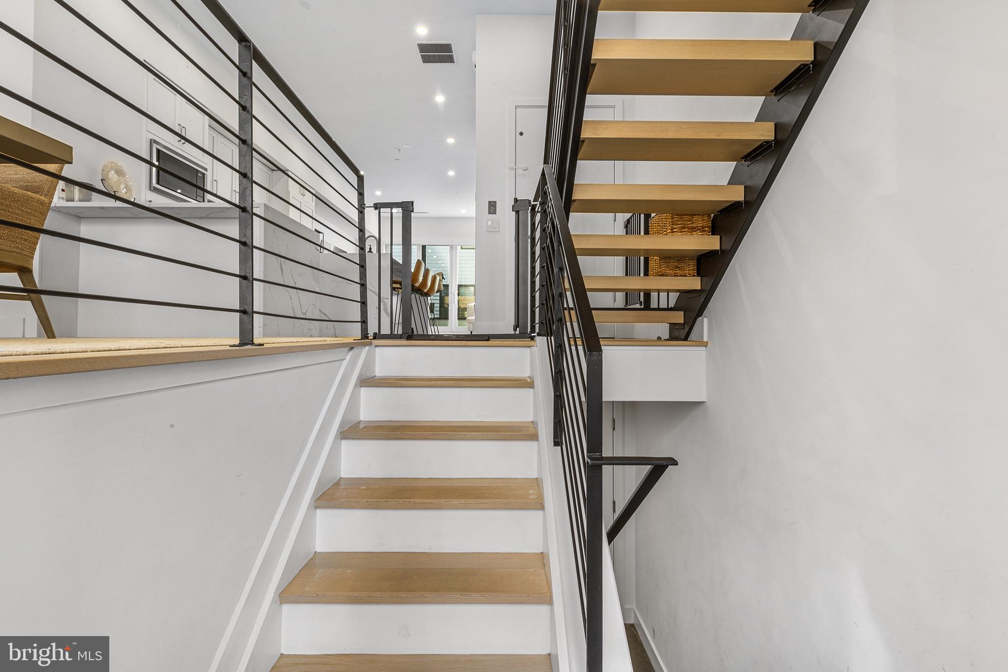116 North Croskey Street Philadelphia, PA 19103 - Photo 6 of 57 a view of staircase with white walls and a window