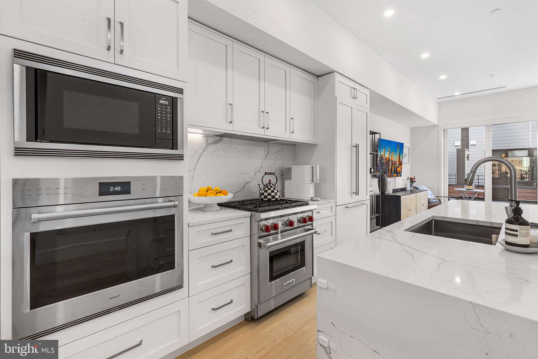 116 North Croskey Street Philadelphia, PA 19103 - Photo 7 of 57 a kitchen with stainless steel appliances a stove microwave and sink