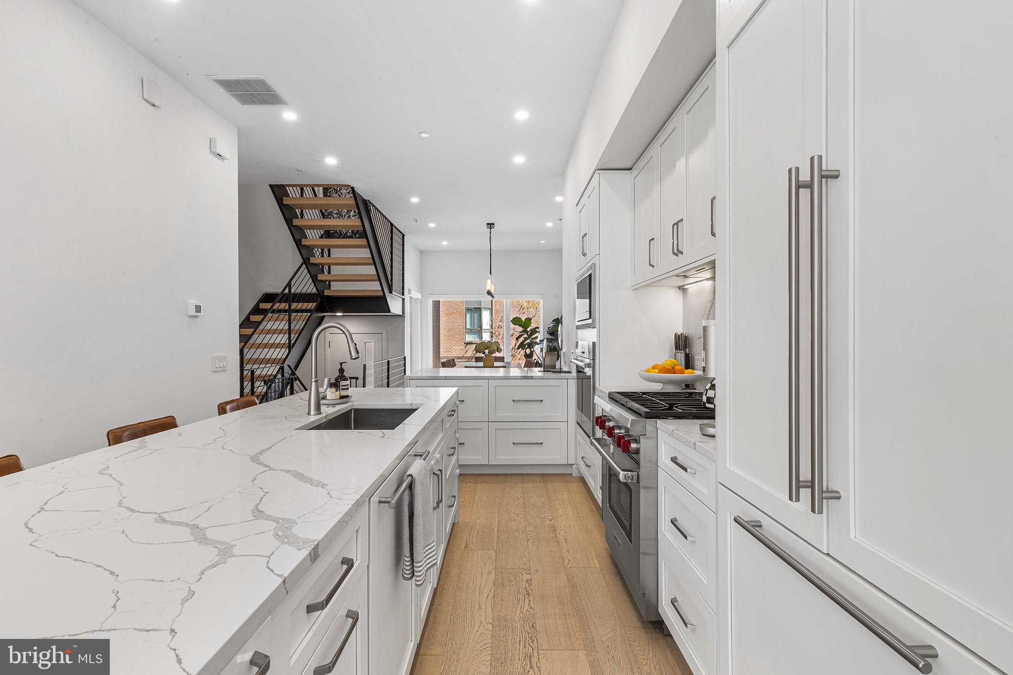116 North Croskey Street Philadelphia, PA 19103 - Photo 8 of 57 a kitchen with stainless steel appliances granite countertop a stove and a sink
