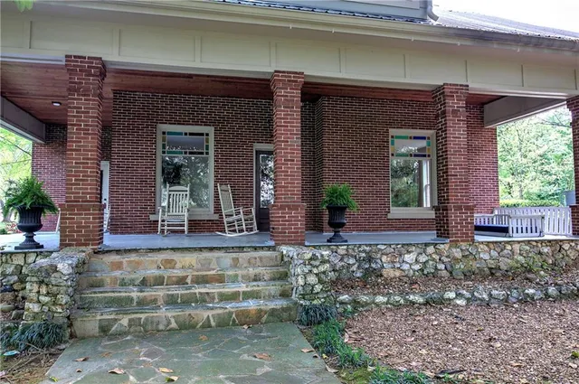 a front view of a house with a garden