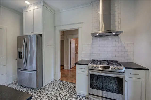 a view of empty room with wooden floor and fireplace