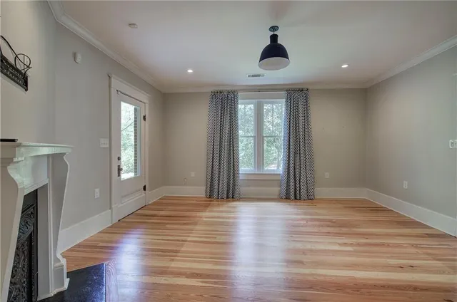 a view of a house with potted plants and a table and chairs