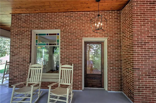 a front view of a house with a garden and patio