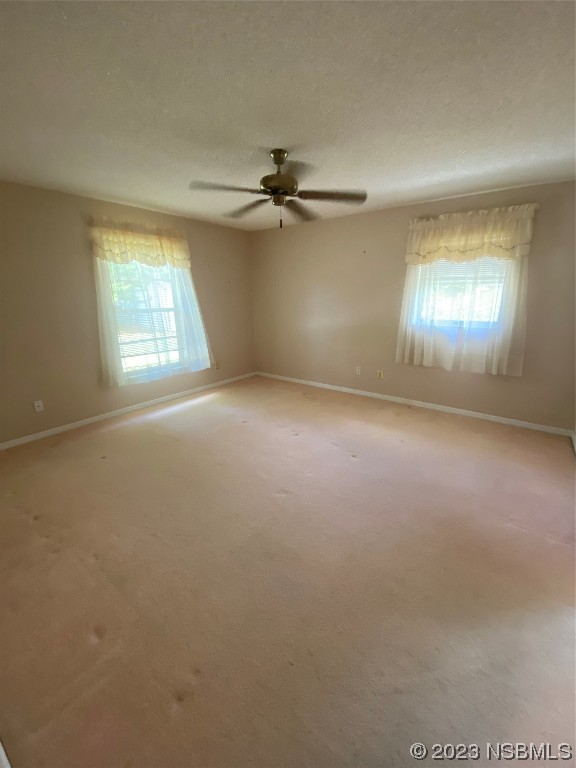 1603 Willow Oak Drive Edgewater, FL 32132 - Photo 16 of 26 an empty room with windows and fan