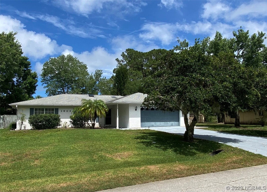 1603 Willow Oak Drive Edgewater, FL 32132 - Photo 2 of 26 a front view of a house with a yard