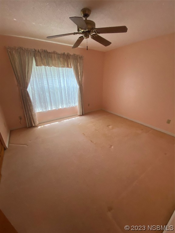 1603 Willow Oak Drive Edgewater, FL 32132 - Photo 21 of 26 a view of a room with a ceiling fan and a window