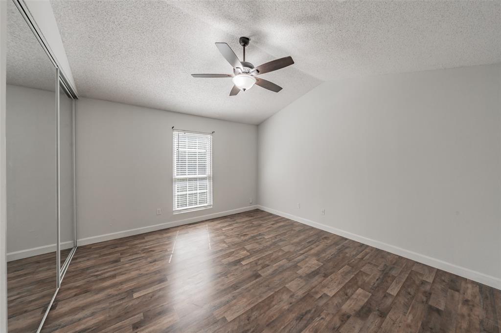 193 Merlin Way Euless, TX 76039 - Photo 19 of 35 Spacious bedroom featuring vinyl wood look flooring, and window with blinds.