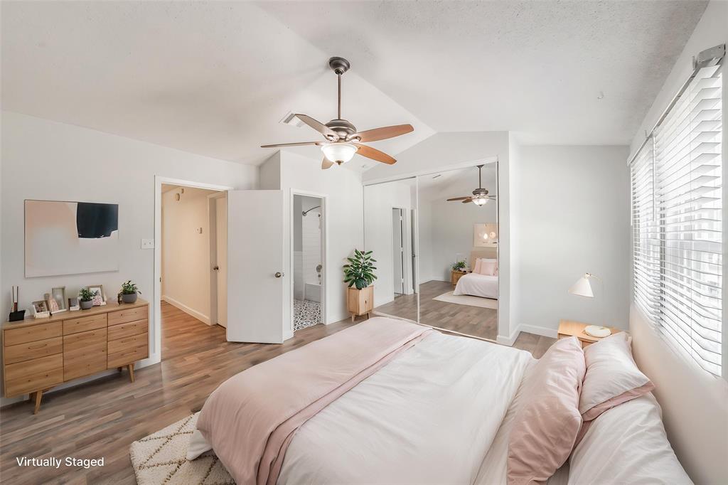 193 Merlin Way Euless, TX 76039 - Photo 24 of 35 Virtually staged bedroom featuring vaulted ceiling, a ceiling fan, and mirrored sliding closet doors
