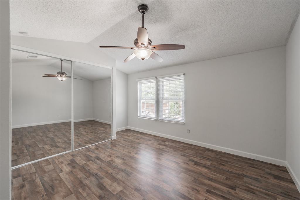 193 Merlin Way Euless, TX 76039 - Photo 25 of 35 Bedroom featuring vinyl wood look flooring, a ceiling fan, and two windows with blinds
