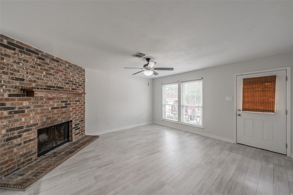 193 Merlin Way Euless, TX 76039 - Photo 4 of 35 Spacious bright living room features blinds on windows for added privacy.