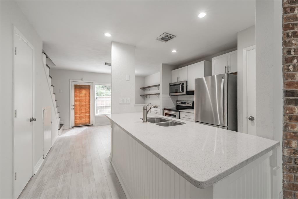 193 Merlin Way Euless, TX 76039 - Photo 6 of 35 Kitchen island with beautiful quartz countertops