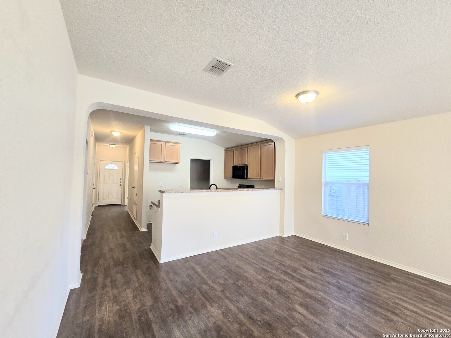 2711 Skybound San Antonio, TX 78245 - Photo 16 of 23 a view of a living room with wooden floor and kitchen space