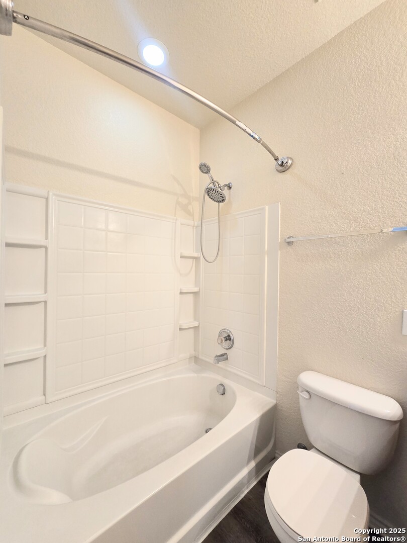 2711 Skybound San Antonio, TX 78245 - Photo 17 of 23 a white toilet sitting next to a bath tub and shower