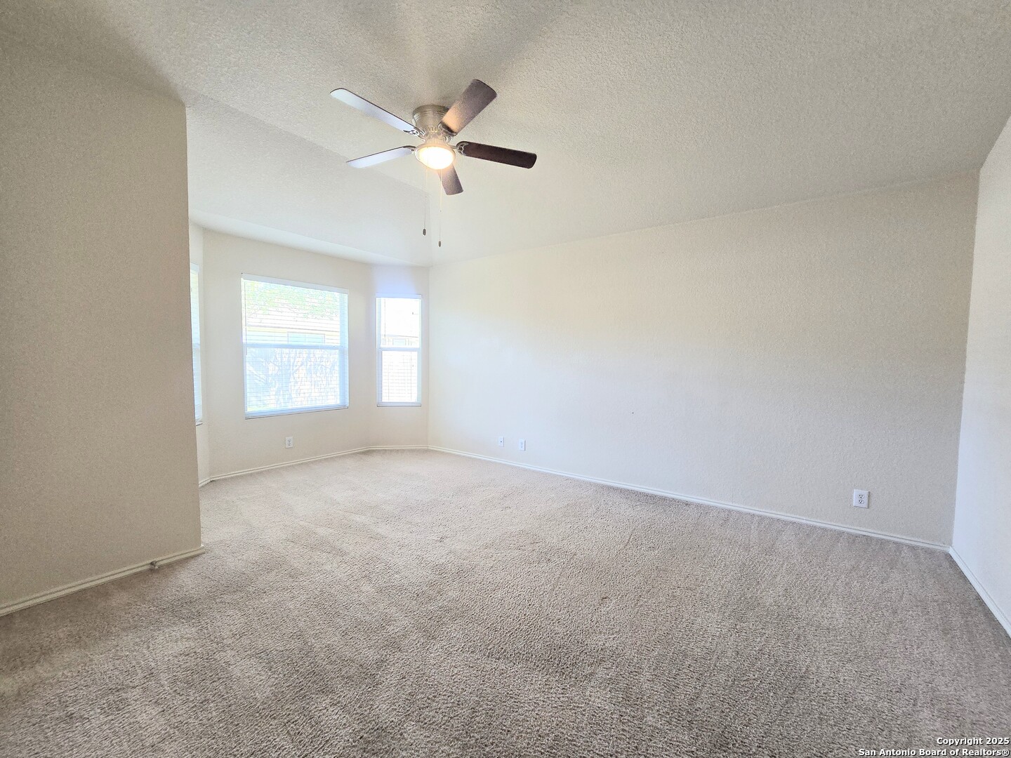 2711 Skybound San Antonio, TX 78245 - Photo 20 of 23 an empty room with windows and fan