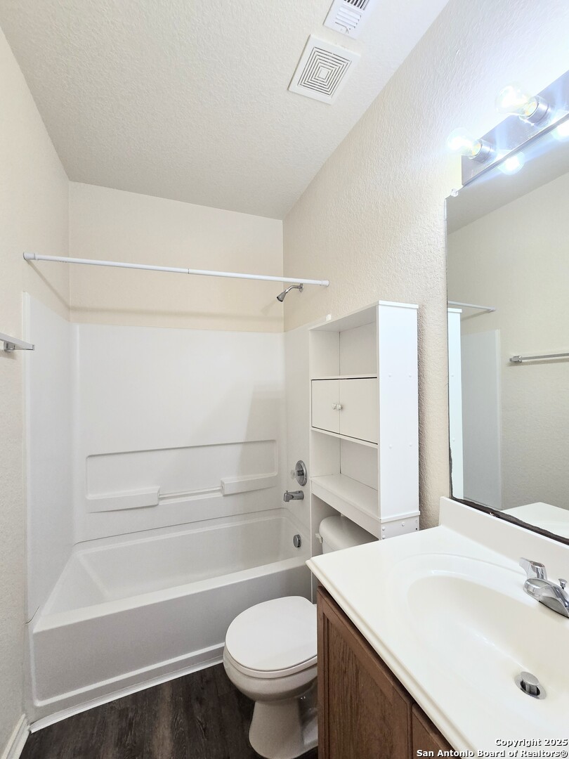 2711 Skybound San Antonio, TX 78245 - Photo 8 of 23 a bathroom with a sink a toilet and a bathtub