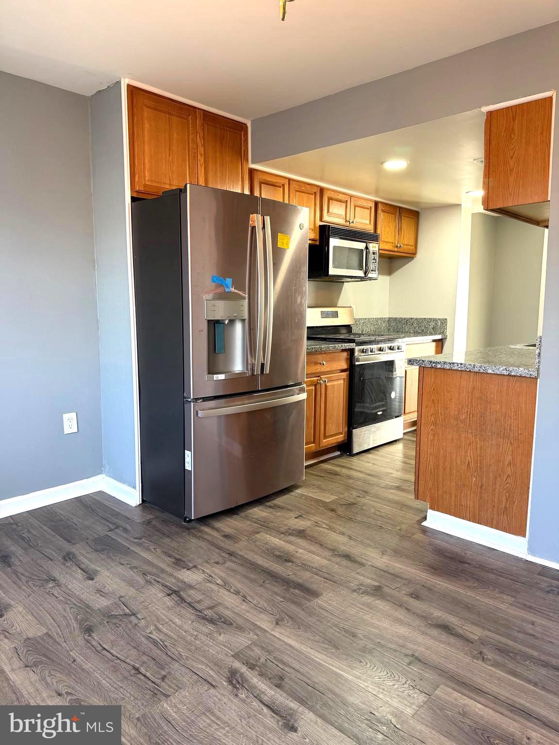 2346 Sun Valley Circle, Unit 2A Silver Spring, MD 20906 - Photo 3 of 21 a kitchen with stainless steel appliances granite countertop a refrigerator and a stove