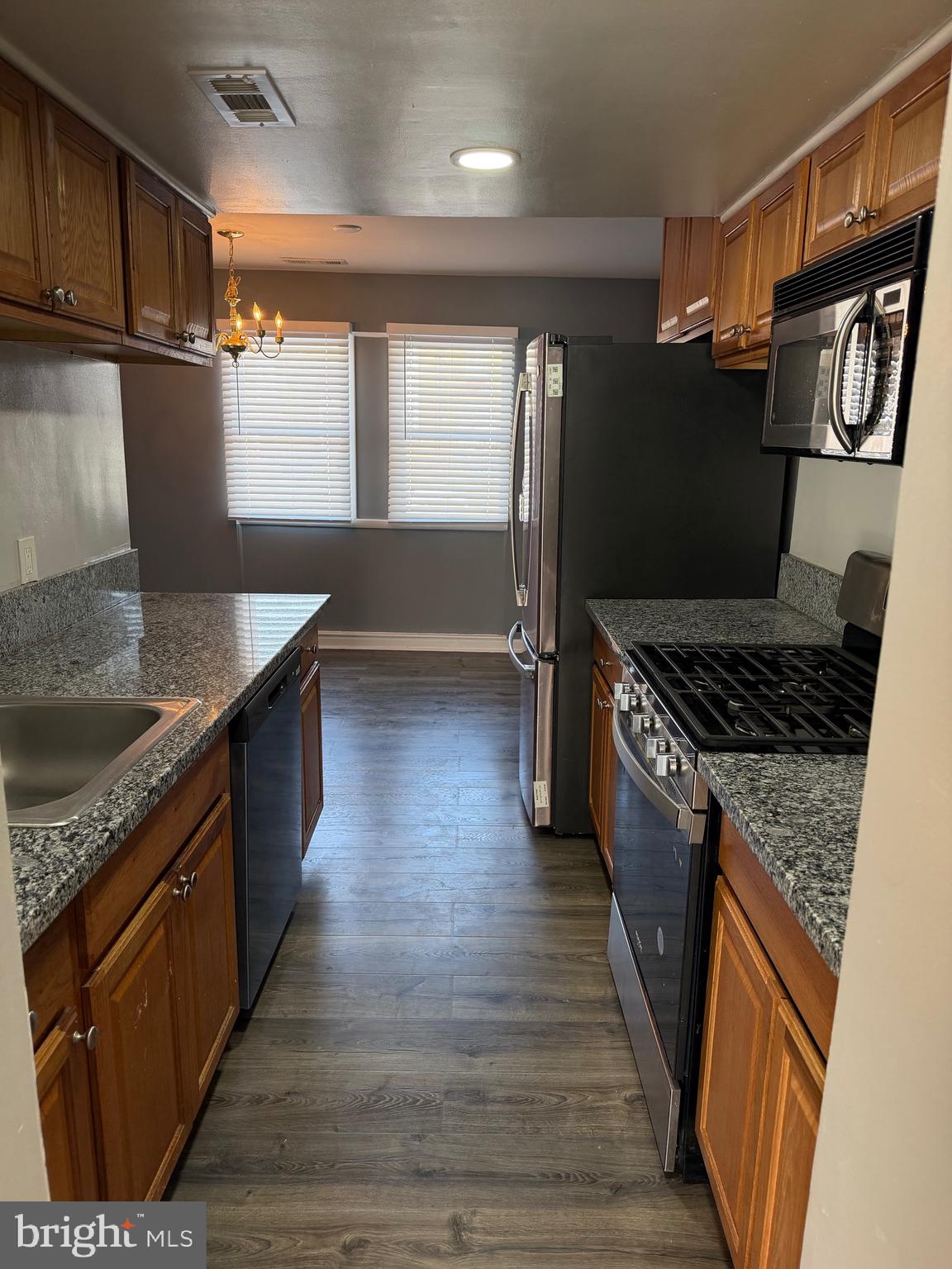 2346 Sun Valley Circle, Unit 2A Silver Spring, MD 20906 - Photo 4 of 21 a kitchen with granite countertop a sink stove and refrigerator