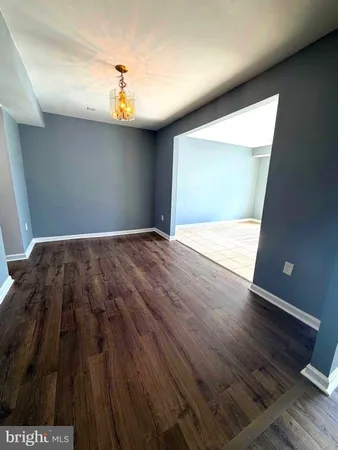 a view of an empty room and wooden floor