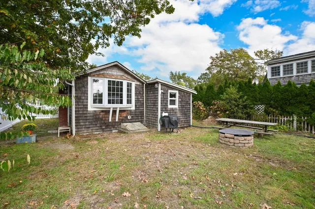 a view of a house with a yard and sitting area