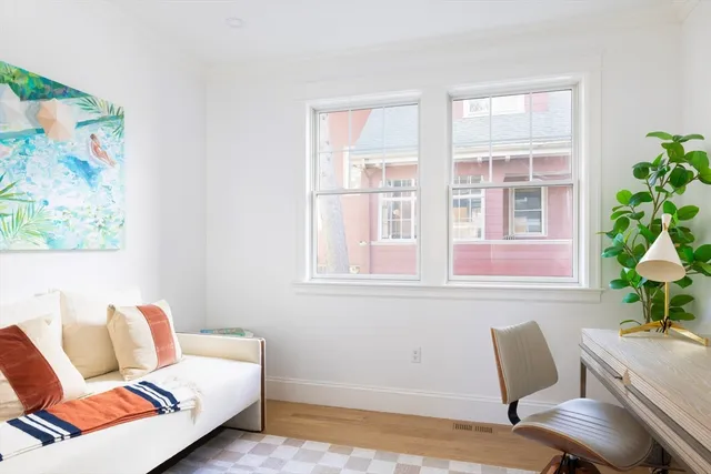 a living room with furniture and a potted plant