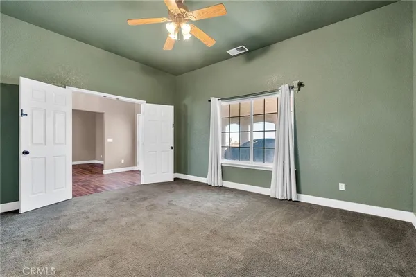 a view of a livingroom with a hardwood floor and a ceiling fan