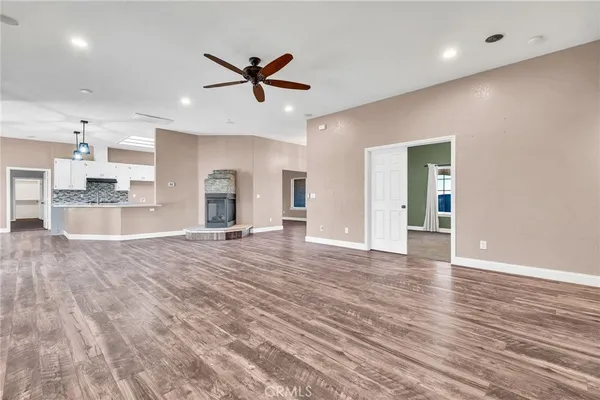 a view of a livingroom with a ceiling fan and window