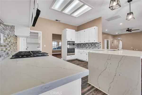 a close view of kitchen stove with white cabinets