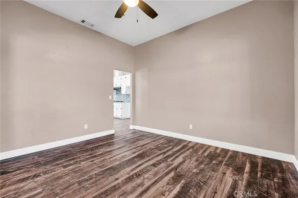 an empty room with closet and a chandelier fan