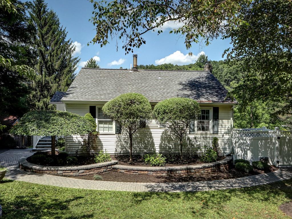 Please come in.... this photo is very deceiving!  But while you're here you can admire the hardscape and mature landscaping.