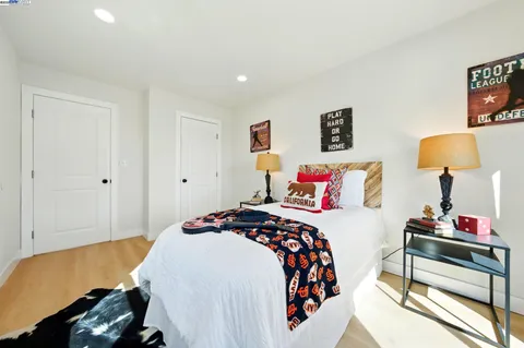 a bedroom with a bed and wooden floor