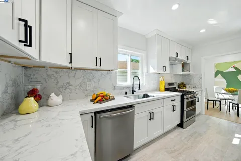 a living room with furniture a lamp and a potted plant