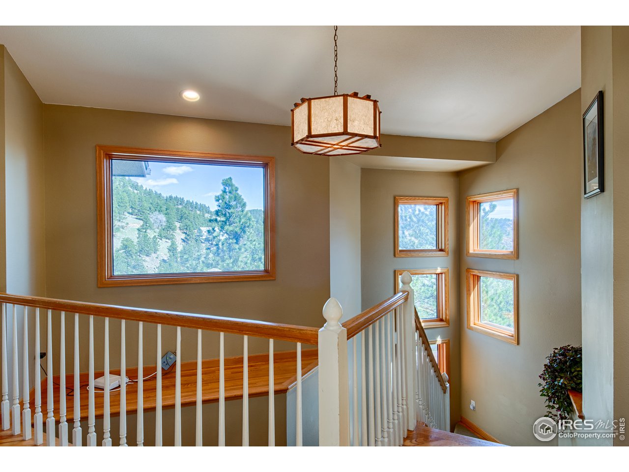 112 Bow Mountain Road Boulder, CO 80304 - Photo 19 of 40 a view of a hallway with windows